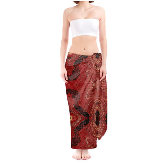 This image displays the "Sarong - Insistent," a stylish and versatile garment showcased in a vivid red and dark brown patterned fabric. The sarong is modeled as a flowing skirt, elegantly draping over the lower half of the body, highlighting its sleek and lightweight design.